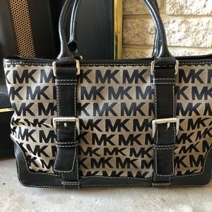 Michael Kors Black and Tan handbag .